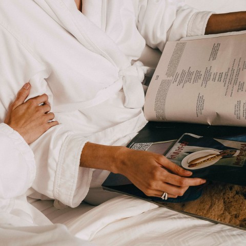 a person in a white robe reading a book
