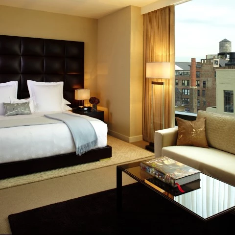 a bedroom with a bed and a couch