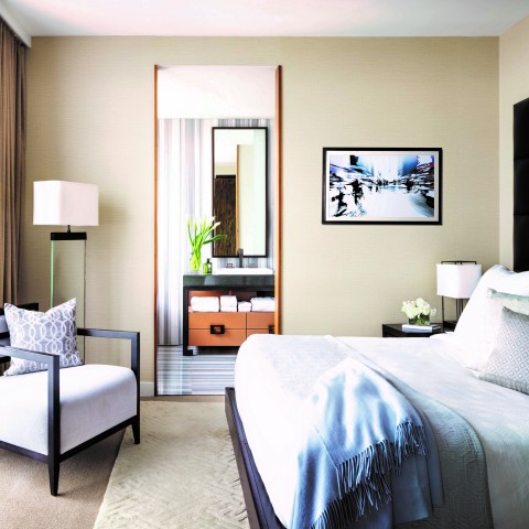 a bedroom with a bed and a chair