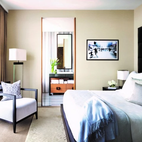 a bedroom with a bed and a chair