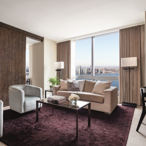 a living room with a view of a city and a bay