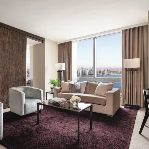 a living room with a view of a city and a bay