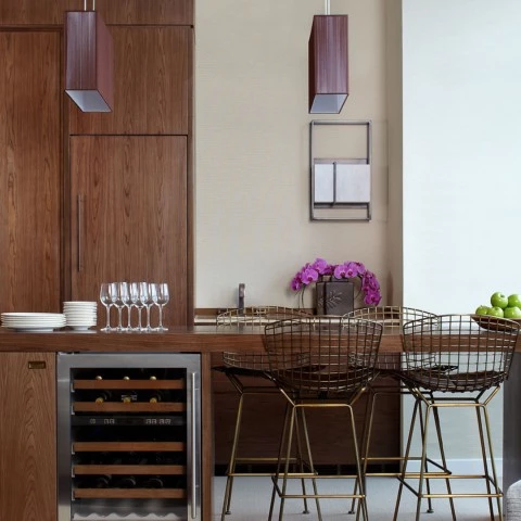 a kitchen with a bar and wine rack