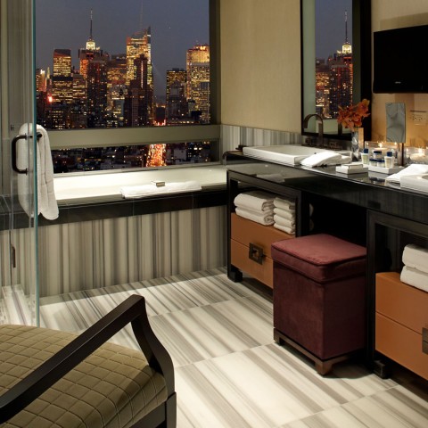 a bathroom with a view of a city