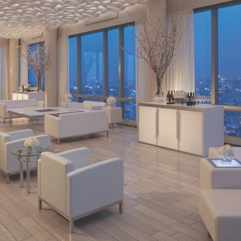 a room with white furniture and tables and chairs