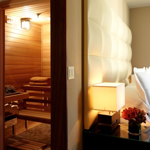 a room with a sauna and a bed