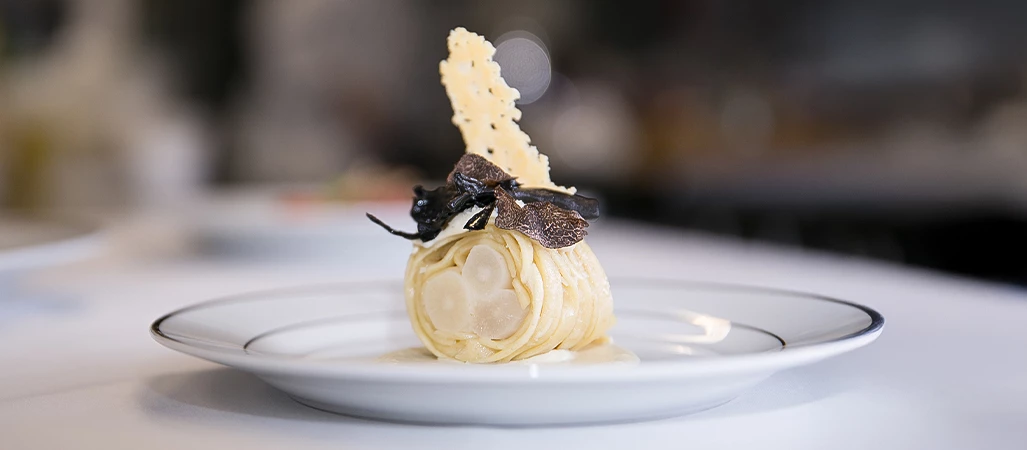 a plate of pasta with truffle and cheese