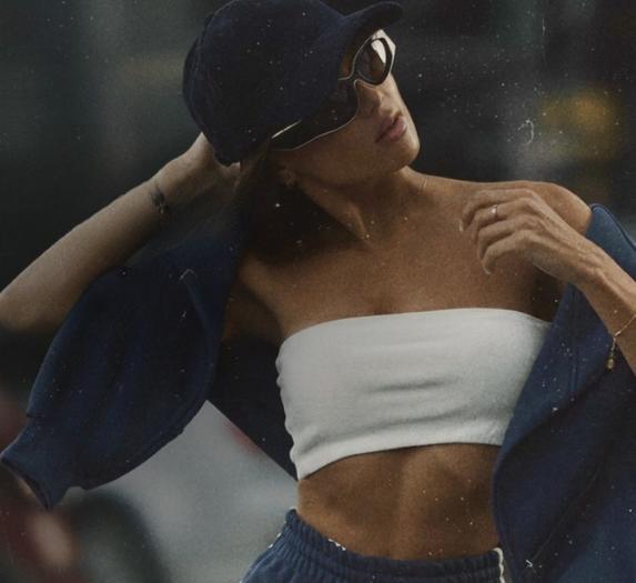 a woman wearing a hat and sunglasses
