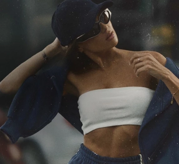 a woman wearing a hat and sunglasses