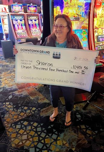a woman holding a check