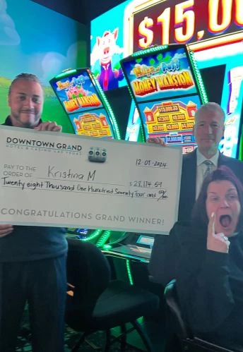 a group of people holding a large check