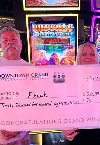 a man and woman holding a large check