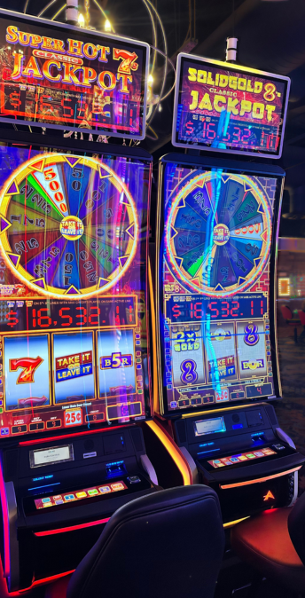 a two slot machines with a colorful display