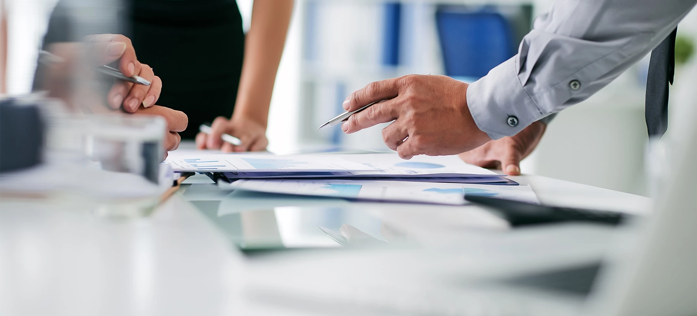 a close-up of people writing on a piece of paper