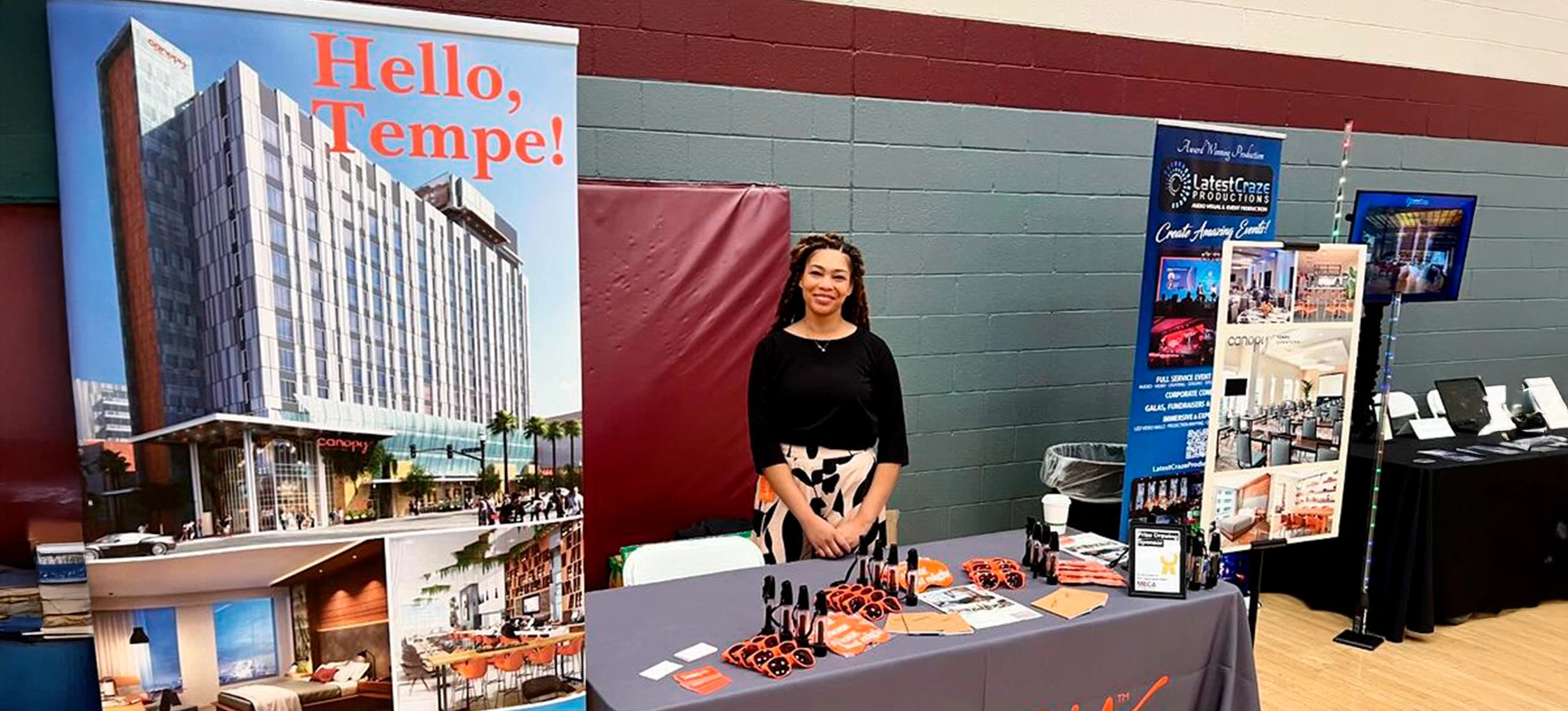 a woman standing in front of a table with makeup products