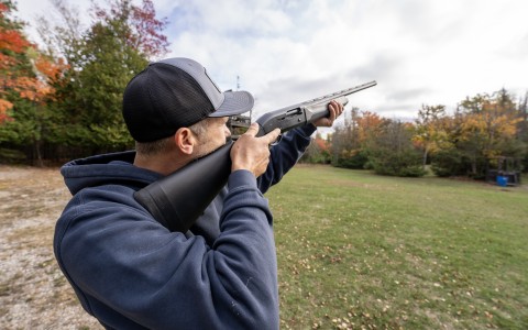 a man holding a shotgun