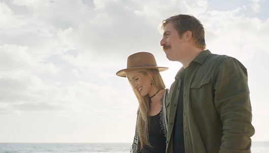 couple taking a relaxing walk along the lake