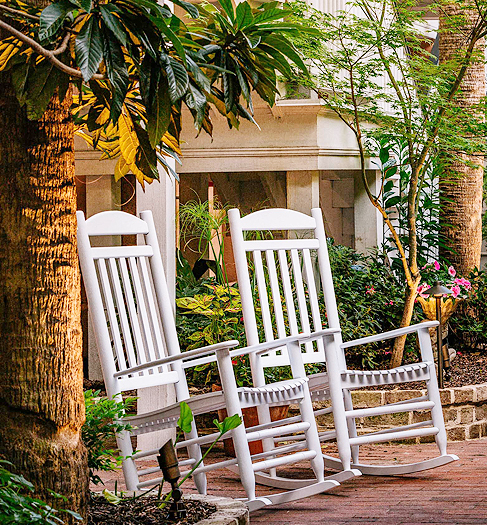 courtyard with two white rocking chairs