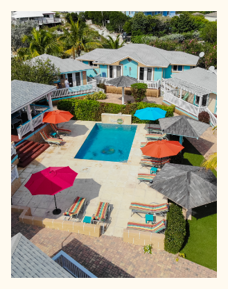 a pool with umbrellas and chairs in a resort