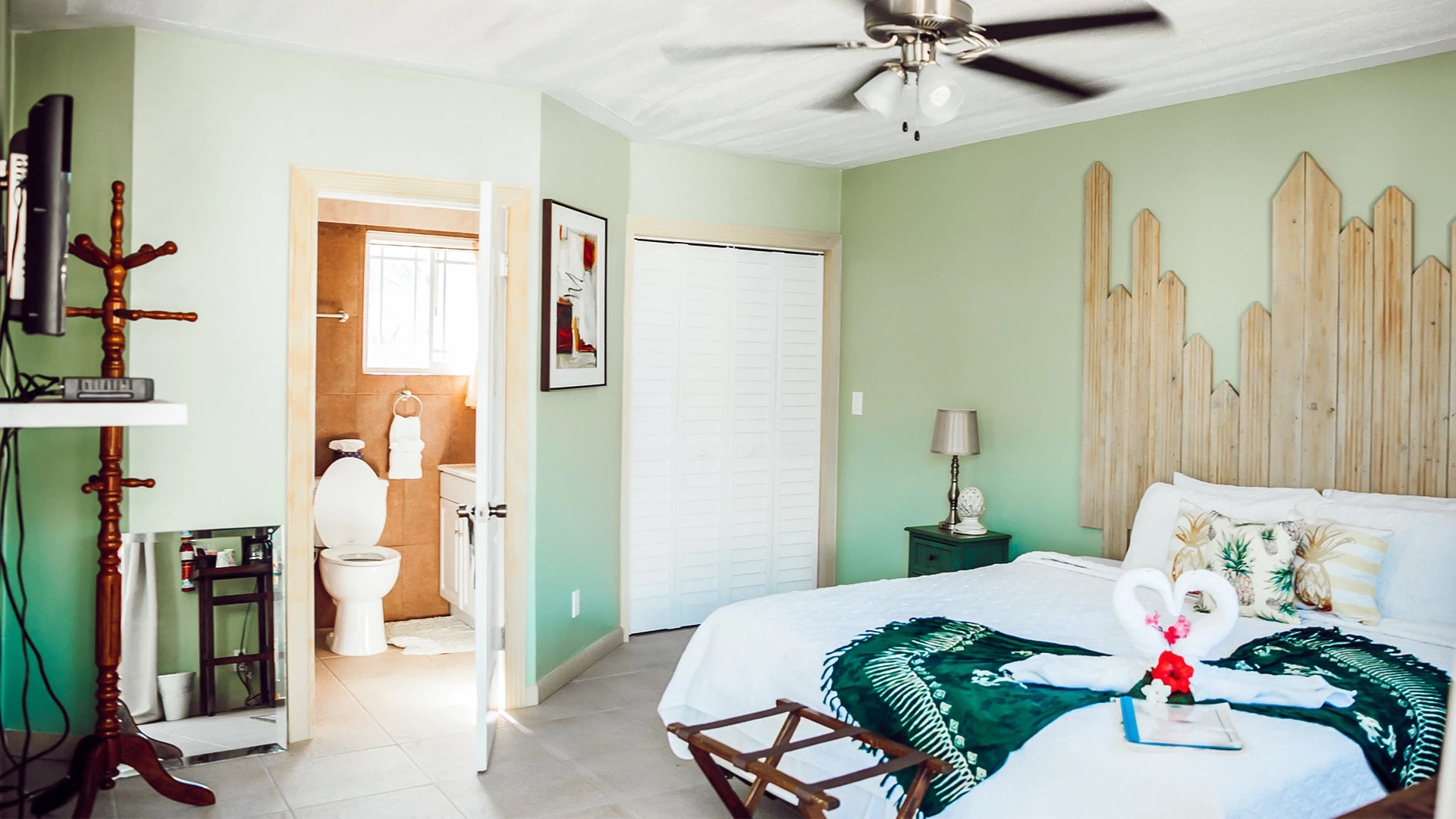 a bedroom with a fan and a bed