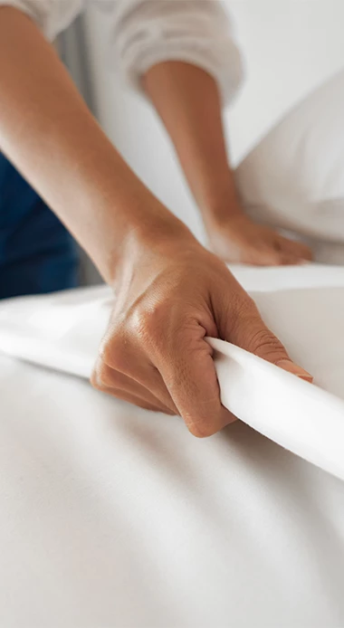 a hand rolling a white sheet