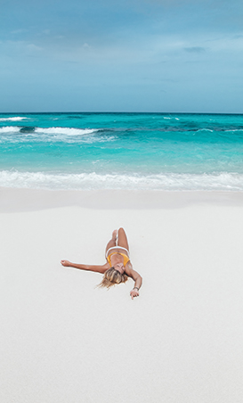 a woman lying on a beach