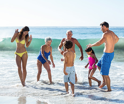a group of people in swimsuits playing in the water