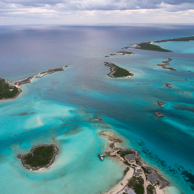 an aerial view of a body of water with islands and buildings