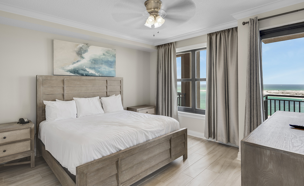 a bedroom with a bed and a ceiling fan