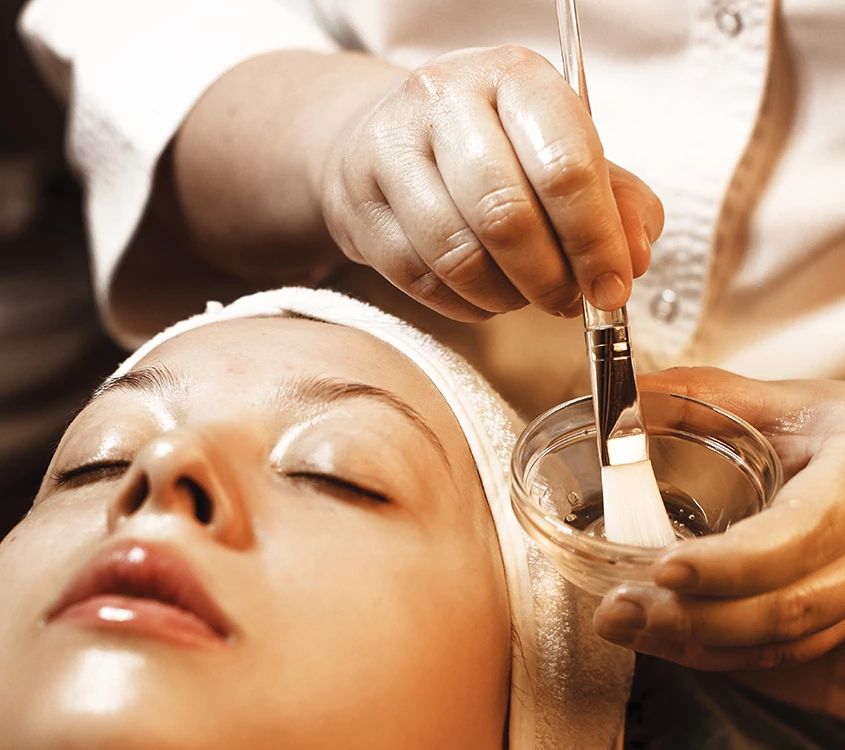 a woman getting a face mask