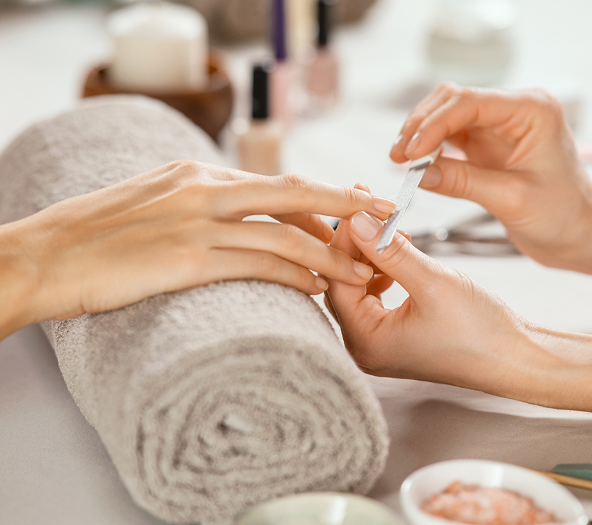 a person getting manicure done