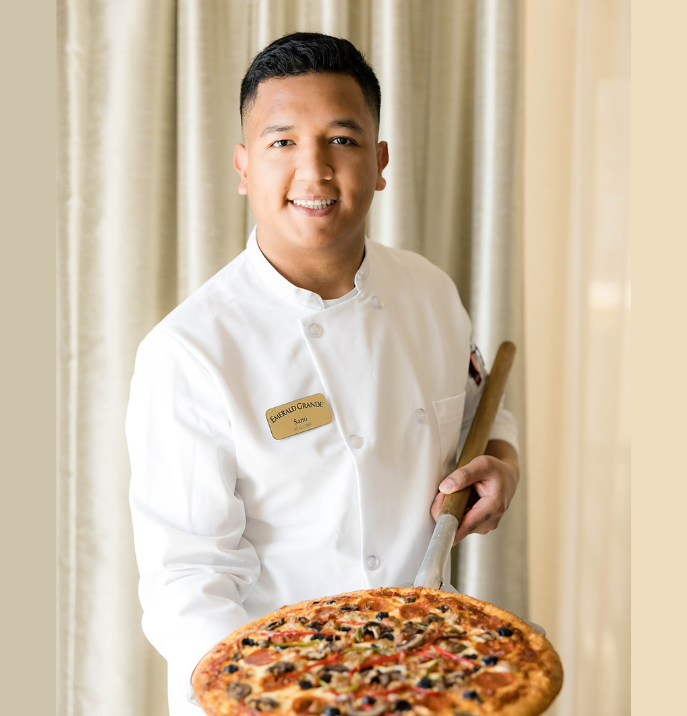 a man holding a pizza