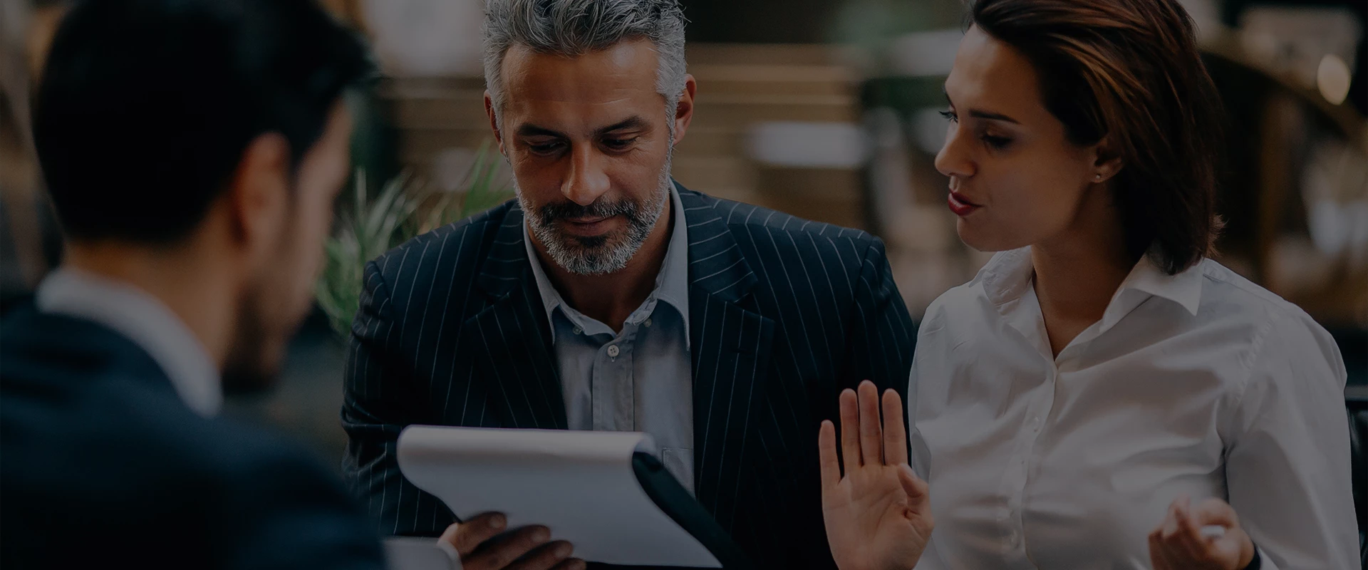 a man and woman looking at a paper