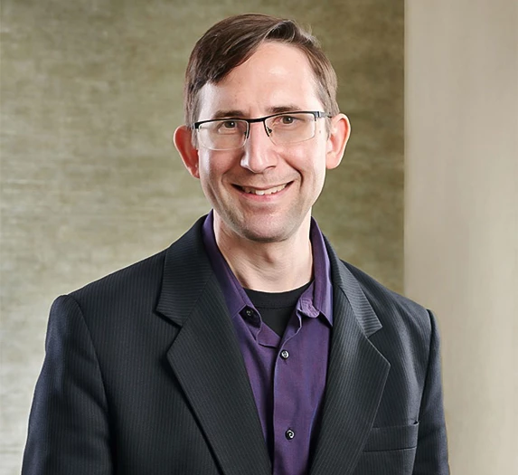 a man in a suit and glasses