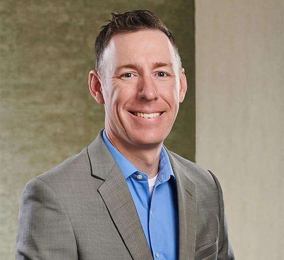 a man in a suit smiling