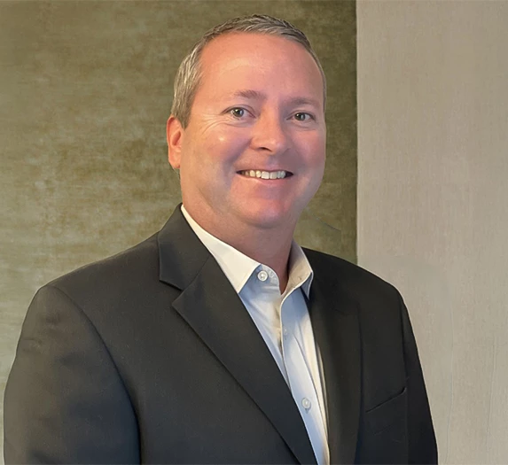a man in a suit smiling