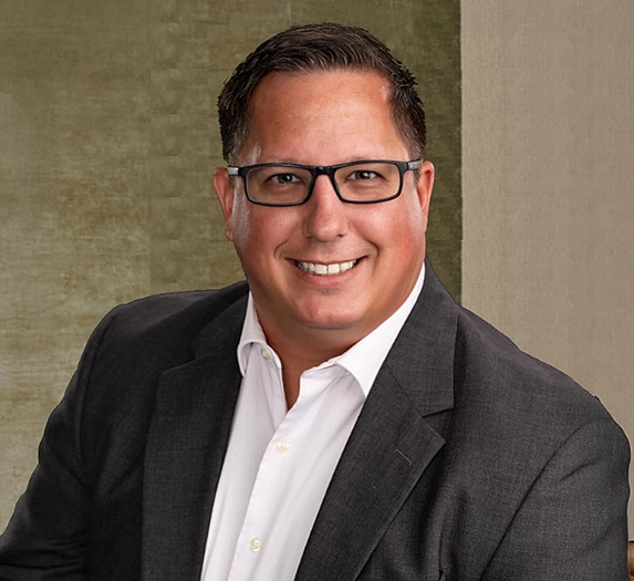 a man in a suit and glasses