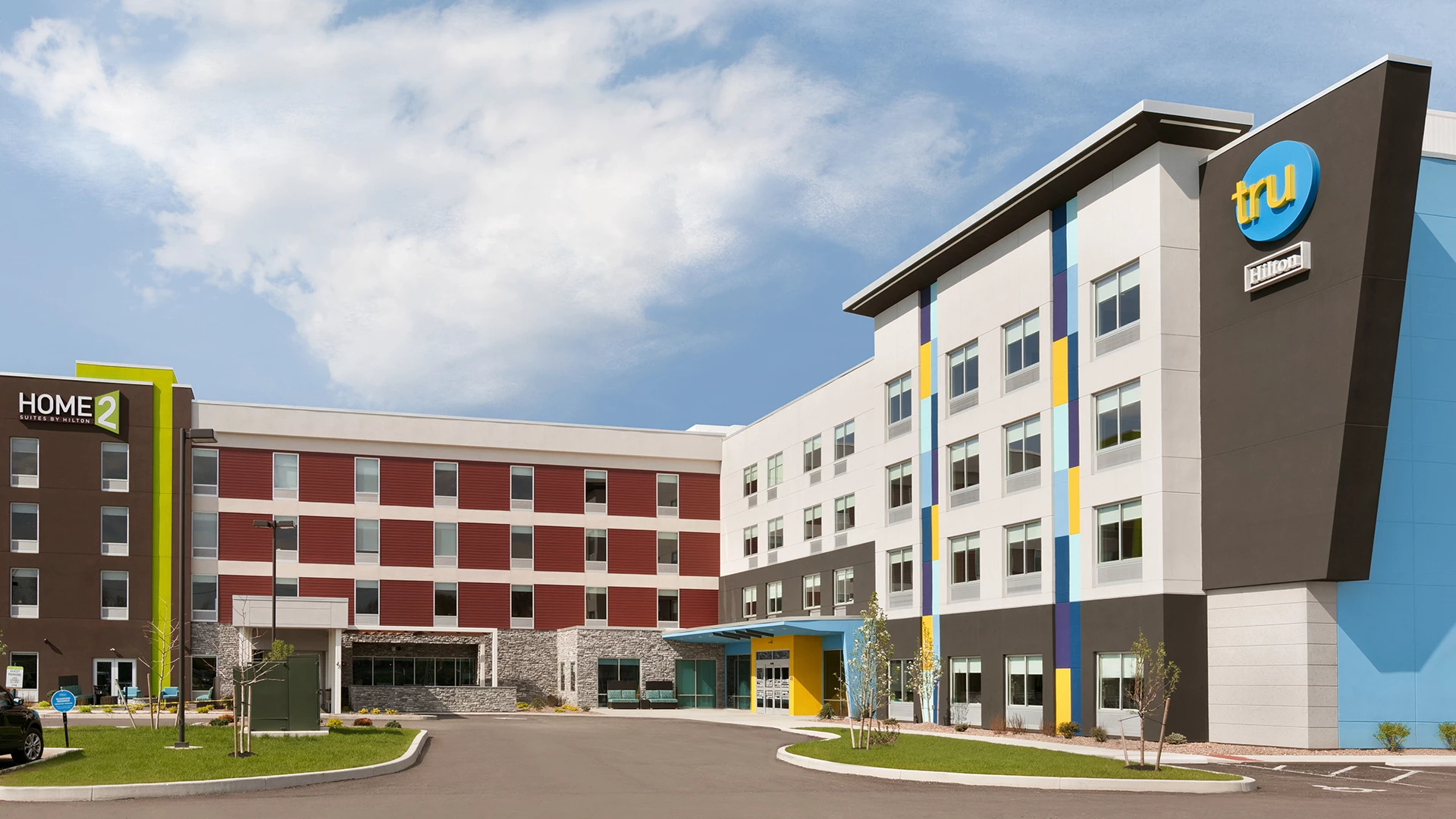 a multistory building with a parking lot