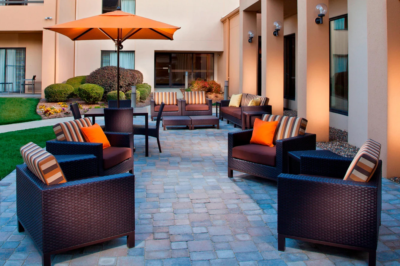a patio area with chairs and umbrellas