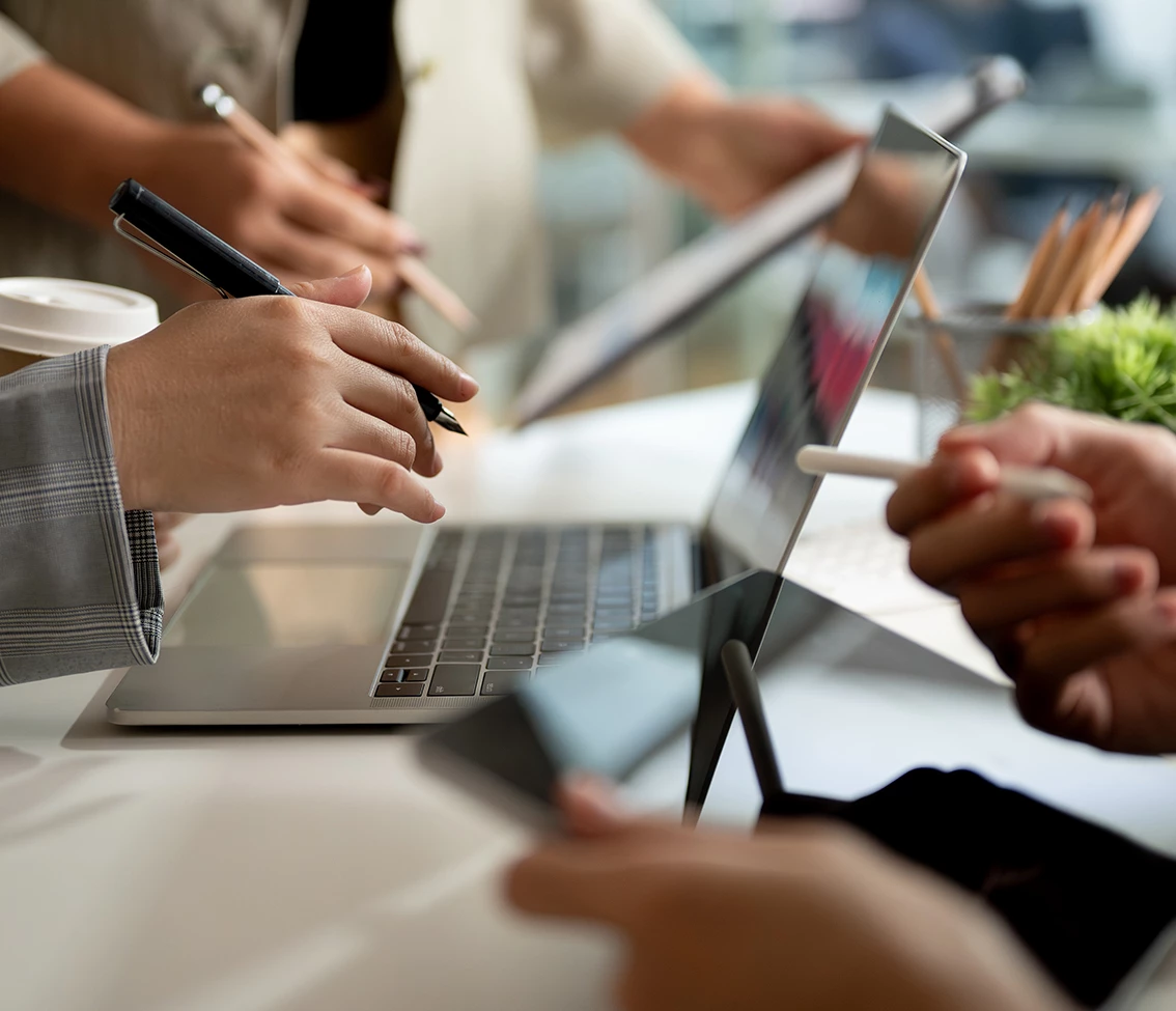 a group of people working on a laptop