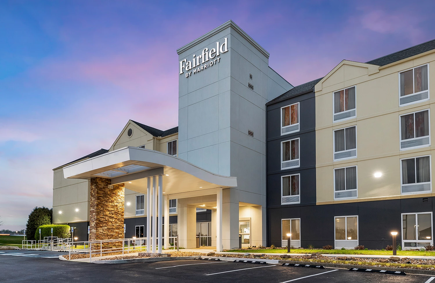 a building with a parking lot and a sign