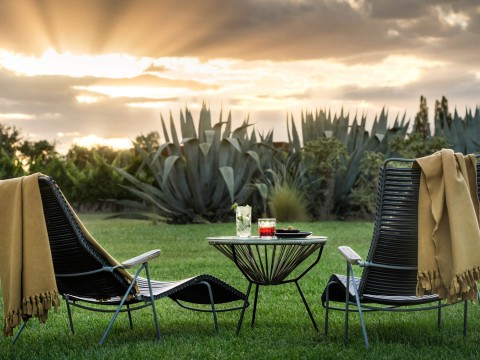 chairs and a table in a grassy area
