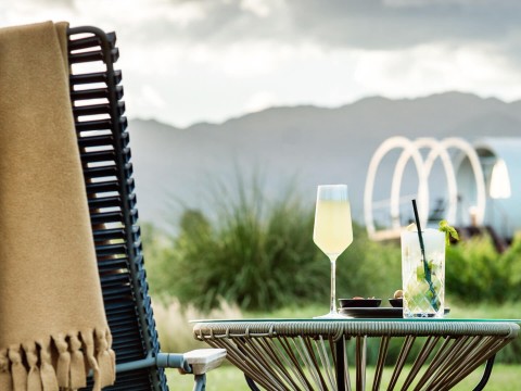 a table with a drink and a towel on it