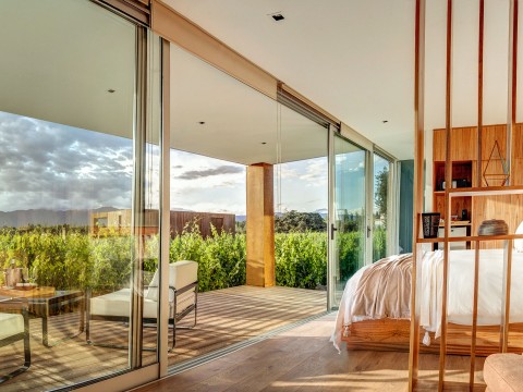 a bedroom with glass doors and a wood floor