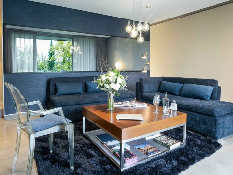 a living room with blue couches and a coffee table
