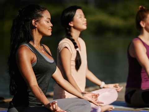a group of women meditating on yoga mats