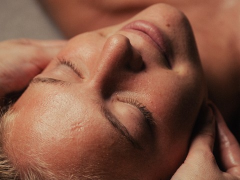 a woman lying down with her eyes closed