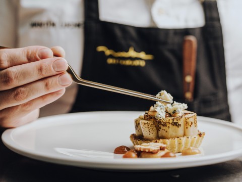 a person holding a fork over a plate of food
