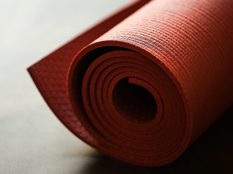 a red yoga mat on a surface