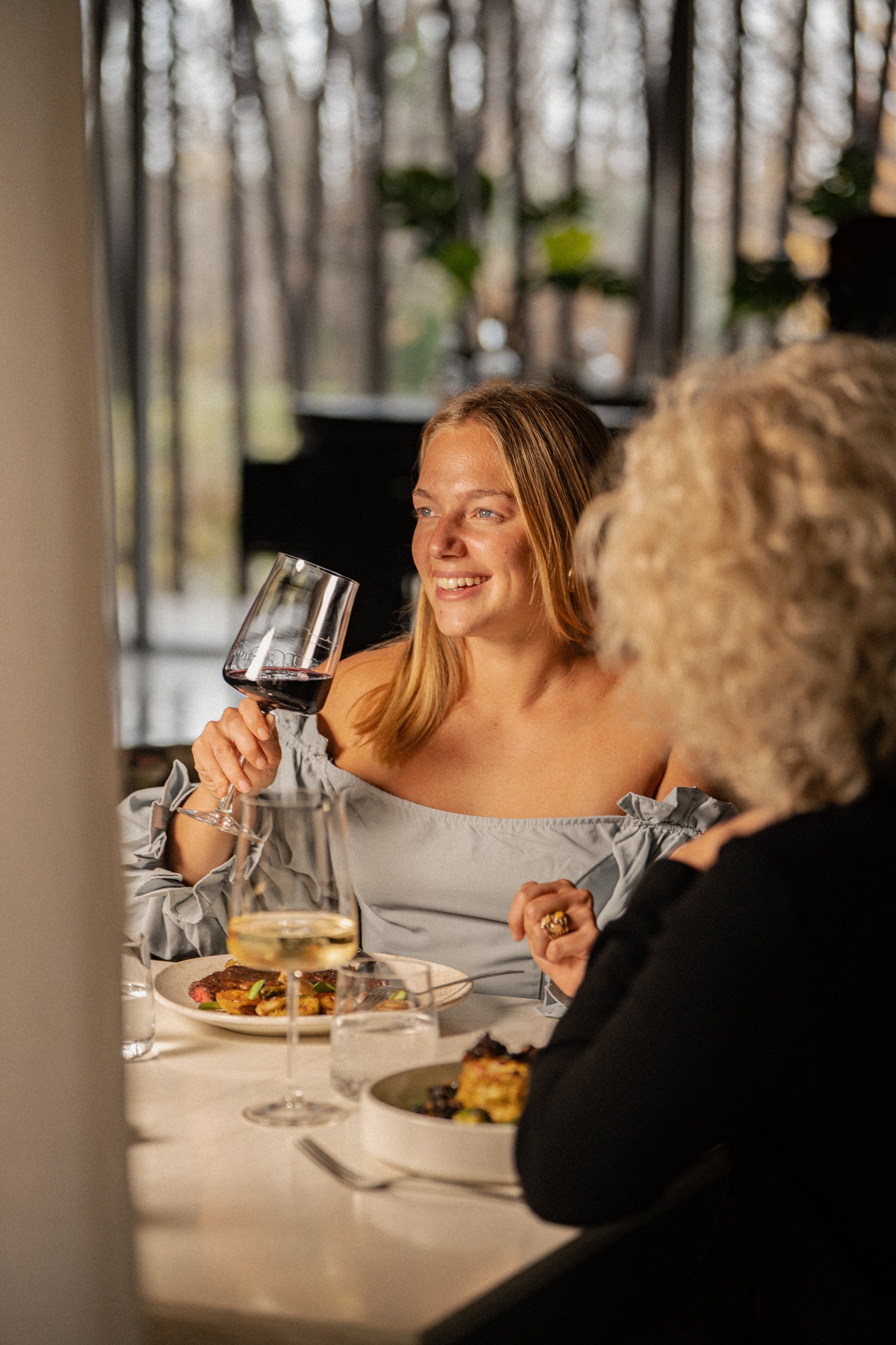 a woman holding a glass of wine